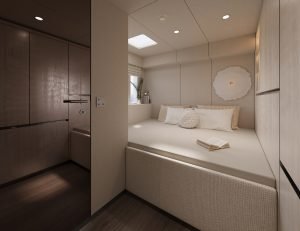The image shows the interior of a Sunreef Yachts cabin with a neatly made bed, an open book on the bed, and elegant, muted decor.