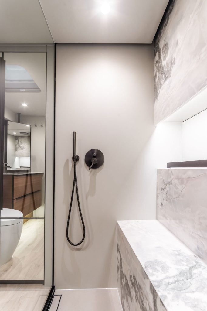 A luxurious bathroom interior on a Sunreef Yachts vessel, featuring elegant fixtures, marble details, and a spacious shower area.