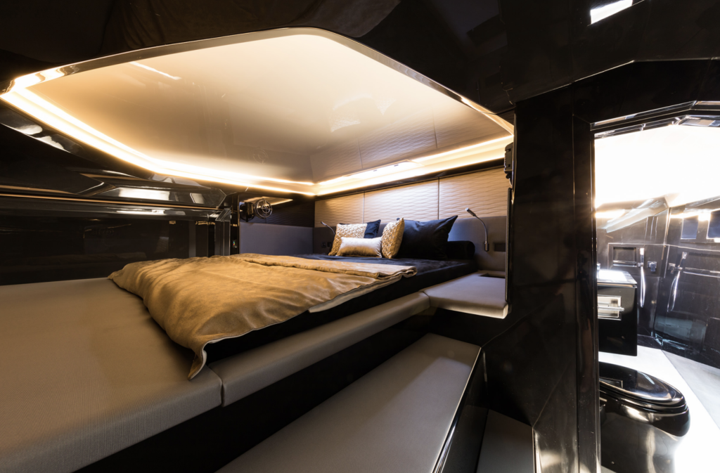 Interior view of a luxury Sunreef Yachts cabin with modern design. The cabin features a large, comfortable bed and sleek, ambient lighting, creating a cozy and upscale atmosphere.
