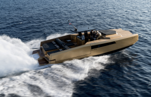 A Sunreef Yachts luxury motorboat glides swiftly over a calm sea, leaving a trail of white foam in its wake. The vessel features a sleek, modern design with a spacious deck area.
