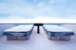 The image shows the deck of a luxury yacht from Sunreef Yachts with two sunbeds facing the ocean, under a clear blue sky.